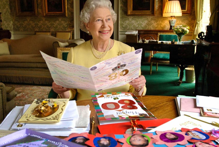 London, United Kingdom:  Britain's Queen Elizabeth II sits in the Regency Room at Buckingham Palace in London 19 April 2006 as she looks at some of the cards which have been sent to her for her 80th birthday. Buckingham Palace said that so far she has received 20,000 cards and 17,000 emails. The Queen celebrates her actual 80th birthday Friday 21 April with a walkabout in Windsor town followed by a dinner hosted in her honour by her son Prince Charles at Kew Palace in London. AFP PHOTO/Fiona Hanson / WPA/PA  (Photo credit should read FIONA HANSON/AFP via Getty Images)