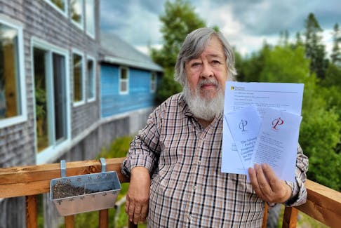 Paul Smitz holds a copy of the Island Party constitution and an Elections P.E.I. statement at his home in Brookvale. The party has officially registered with the elections body and hopes to field candidates in the next election. Stu Neatby • The Guardian
