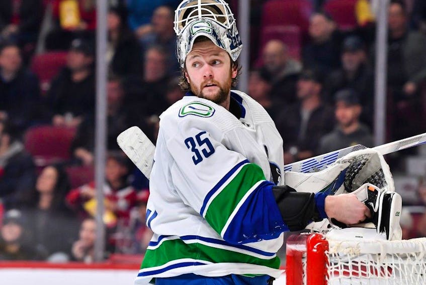 Canucks goalie Thatcher Demko adjusts his gear during a break in their Nov. 9, 2022 NHL game against the host Montreal Canadiens at the Bell Centre.