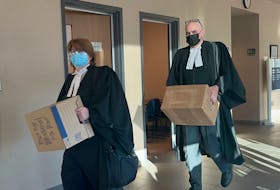 Crown attorneys Saara Wilson and Bob Morrison carry boxes of materials into the Yarmouth courtroom, where a homicide trial is underway. TINA COMEAU