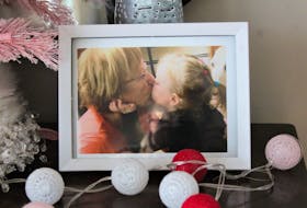 A photo of Charlene Snow giving her granddaughter Nora Snow a kiss which is in the front hall of Nora's home in Donkin. NICOLE SULLIVAN/CAPE BRETON POST