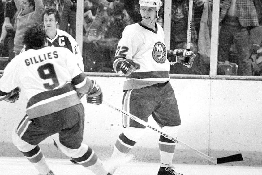 Mike Bossy, right, of the New York Islanders, celebrates after he scored the winning goal in overtime to beat the Toronto Maple Leafs 3-1 at the Nassau Coliseum in Uniondale, N.Y., on April 20, 1978. At left are Clark Gillies of the Islanders and the Maple Leafs' captain Darryl Sittler. 