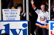 Hockey Hall of Famer and former New York Islander Mike Bossy waves to fans as he is introduced before a game between the Islanders and the Boston Bruins at Nassau Coliseum on Jan. 29, 2015, in Uniondale, N.Y. 