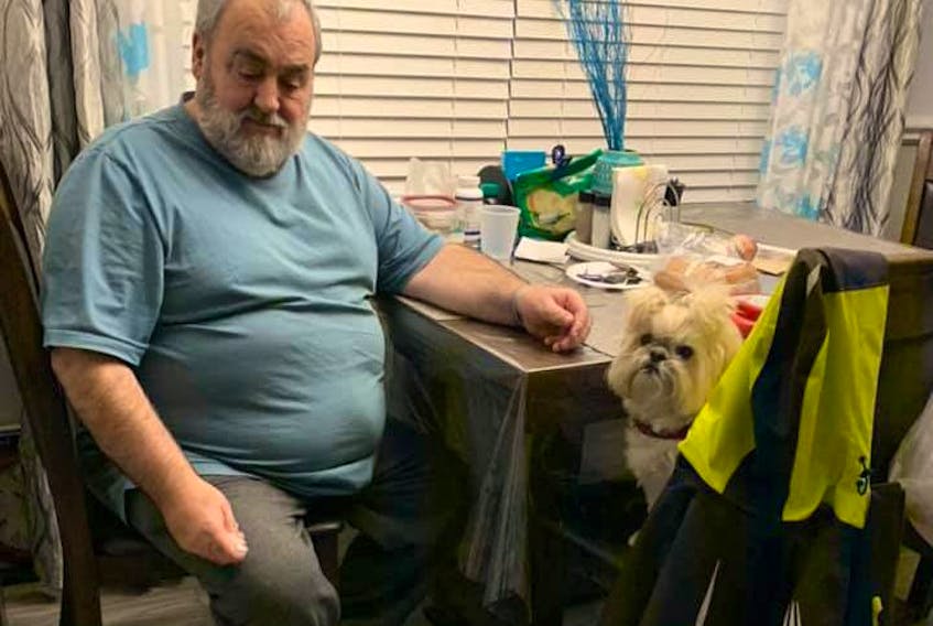 Neddy Boland and his dog Bella. The Corner Brook man has been missing his beloved during the past three and half months that he’s spent in hospital. – Contributed