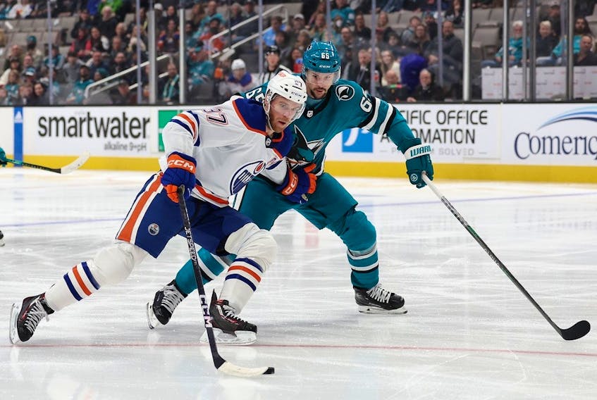  Sharks defenceman Erik Karlsson, right, a former Senators captain, checks Oilers star Connor McDavid in the first period of a game at San Jose on Friday.