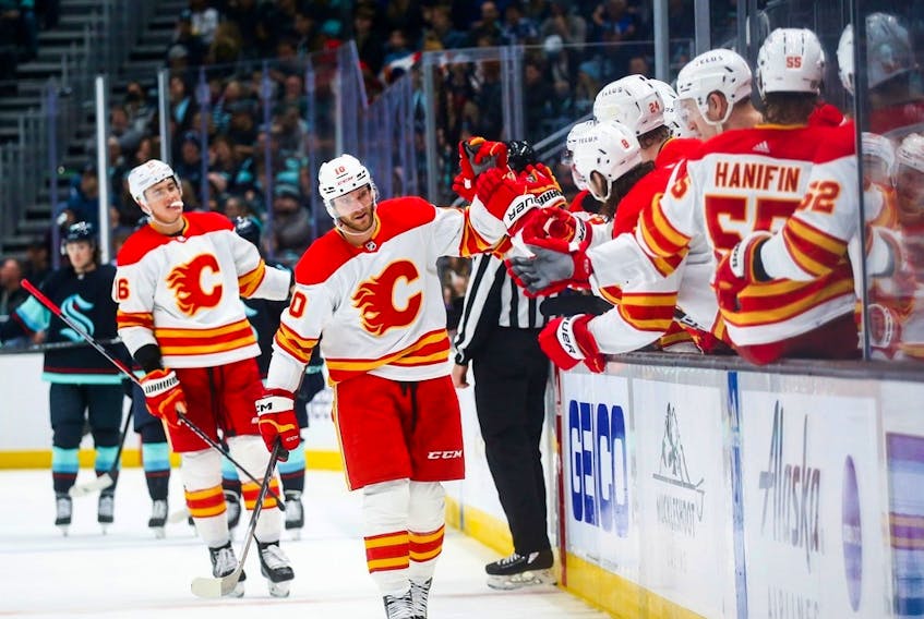 Calgary Flames forward Jonathan Huberdeau is congratulated after scoring against the Seattle Kraken at Climate Pledge Arena in Seattle on Dec. 28, 2022.