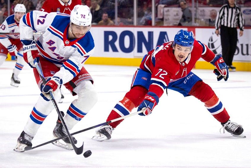 Montreal Canadiens defenceman Arber Xhekaj tips the puck away from New York Rangers centre Filip Chytil in Montreal, on Jan. 5, 2023.