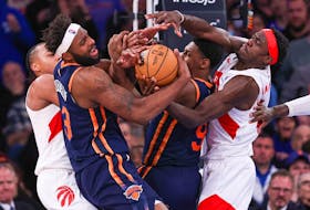 New York Knicks centre Mitchell Robinson (23) and guard RJ Barrett (9) battle for a rebound against Toronto Raptors forward Pascal Siakam (43) and forward Scottie Barnes (4) during the second half at Madison Square Garden on Monday afternoon.