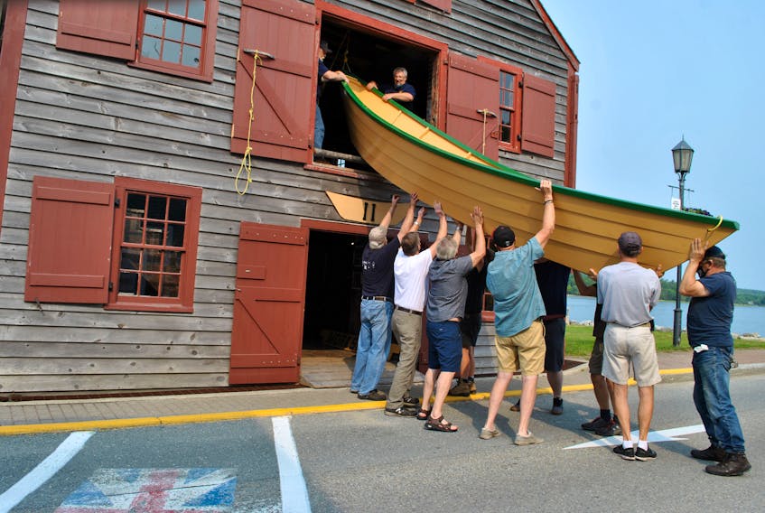 A newly built dory is lowered from the building loft at the Shelburne Dory Shop Museum in the summer of 2021. The Dory Shop Museum is marking its 40th anniversary in 2023. KATHY JOHNSON