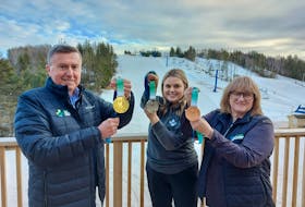 Wayne Carew, left, chair of the board for the P.E.I. 2023 Canada Winter Games, is joined by Lexi Drummond, communications manager, and Jo-Anne Wallace, Team P.E.I. chef de mission, in holding up the medals for the Games. Alison Jenkins • The Guardian