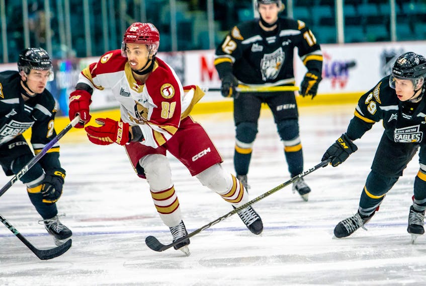 Robert Orr of the Acadie-Bathurst Titan, middle, works his way through a pair of Cape Breton Eagles players during Quebec Major Junior Hockey League action at the K.C. Irving Regional Centre in Bathurst, N.B., on Wednesday. The Eagles won the game 5-4 in overtime. Bryannah James/Acadie-Bathurst Titan.