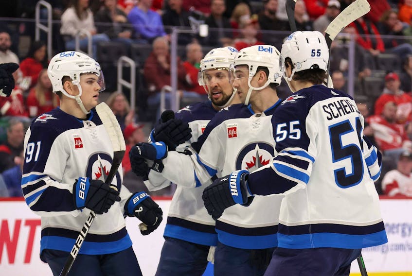 Neal Pionk of the Winnipeg Jets celebrates his first period goal with teammates while playing the Detroit Red Wings at Little Caesars Arena on January 10, 2023 in Detroit, Michigan.  
