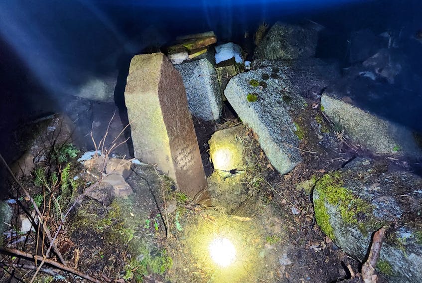 A  number of headstones  were found scattered in the woods of Cow Bay.