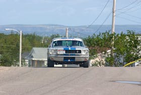 A 1969 Ford Mustang Fastback makes driven by Tom Silver of the United States makes it's way through Seal Cove on the first leg of the 2004 Targa Newfoundland Road Rally Sept. 14, 2004.