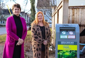 Donna Keenan, left, director of the Community Outreach Centre, and Roxanne Carter-Thompson, executive director of the Adventure Group, stand beside one of three community drop boxes now set up in P.E.I. This unit is at the outreach centre. - Logan MacLean • The Guardian