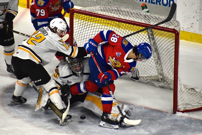 Oliver Satny of the Cape Breton Eagles, middle, battles to keep the puck out of the net as teammate Cam Squires, left, and Yoan Loshing of the Moncton Wildcats battle in front of the net during Quebec Major Junior Hockey League action at Centre 200 in Sydney, Friday. Moncton won the game 5-3. JEREMY FRASER/CAPE BRETON POST.