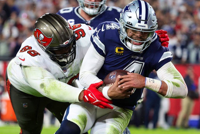 Dallas Cowboys quarterback Dak Prescott rushes the ball for a touchdown against the Tampa Bay Buccaneers defensive end Akiem Hicks in the first half during the wild card game at Raymond James Stadium.  