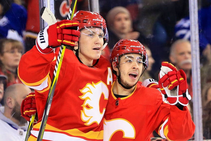  Flames forward Matthew Tkachuk and then-teammate Johnny Gaudreau celebrate a goal during a game this past season.