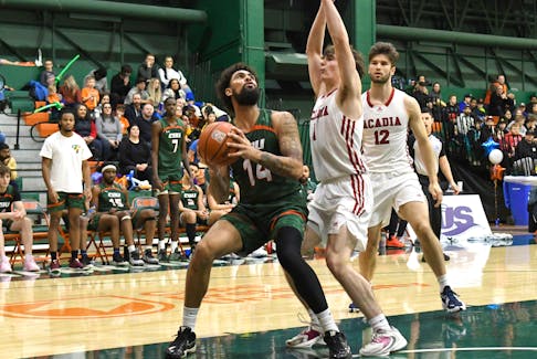 Cape Breton Capers' Paul Watson looks for a shot opportunity as Acadia Axemen's <a aria-label="Gabe Davignon: jersey number 1: full bio" href="https://www.acadiaathletics.ca/sports/mbkb/2022-23/bios/davignon_gabe_zerc" style="margin: 0px; padding: 0px; vertical-align: baseline; background-image: initial; background-position: initial; background-size: initial; background-repeat: initial; background-attachment: initial; background-origin: initial; background-clip: initial; color: rgb(155, 29, 34); -webkit-tap-highlight-color: rgba(201, 224, 253, 0.8); font-family: roboto, arial;">Gabe Davignon</a>, centre, and <a aria-label="Adam Barney: jersey number 12: full bio" href="https://www.acadiaathletics.ca/sports/mbkb/2022-23/bios/barney_adam_ub33" style="margin: 0px; padding: 0px; vertical-align: baseline; background-image: initial; background-position: initial; background-size: initial; background-repeat: initial; background-attachment: initial; background-origin: initial; background-clip: initial; color: rgb(155, 29, 34); -webkit-tap-highlight-color: rgba(201, 224, 253, 0.8); font-family: roboto, arial;">Adam Barney</a> defend during their AUS men's basketball game on Saturday at Sullivan Fieldhouse. CONTRIBUTED/VAUGHAN MERCHANT PHOTO