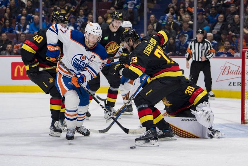  Jan 21, 2023; Vancouver, British Columbia, CAN; Edmonton Oilers forward Connor McDavid (97) drives past Vancouver Canucks defenseman Oliver Ekman-Larsson (23) in the second period at Rogers Arena. 