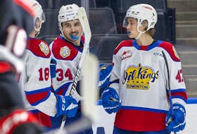 Edmonton Oil Kings Noah Boyko (34) celebrates his goal against the Moose Jaw Warriors with teammates Luca Hauf (18) and Ethan MacKenzie (47) in this file photo from Jan. 10, 2023 .