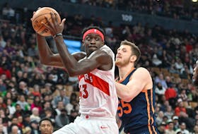 Raptors' Pascal Siakam takes in a rebound beside New York Knicks' Isaiah Hartenstein during  the first half at Scotiabank Arena on Sunday, Jan. 22, 2023. 