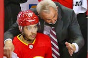  Calgary Flames head coach Darryl Sutter talks with forward Johnny Gaudreau during a game against the Montreal Canadiens at the Scotiabank Saddledome in Calgary on March 13, 2021.