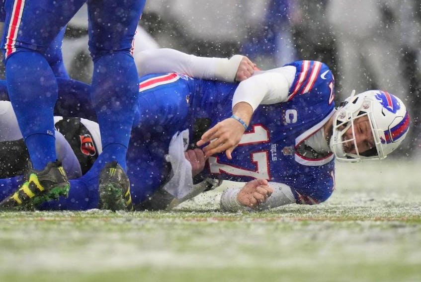 Jan 22, 2023; Orchard Park, New York, USA; Buffalo Bills quarterback Josh Allen is sacked by Cincinnati Bengals defensive end Trey Hendrickson and fumbles in the first quarter during an NFL divisional playoff football game between the Cincinnati Bengals and the Buffalo Bills during an AFC divisional round game at Highmark Stadium.  