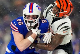 Jan 22, 2023; Orchard Park, New York, USA; Cincinnati Bengals linebacker Germaine Pratt tackles Buffalo Bills tight end Dawson Knox in the fourth quarter during an AFC divisional round game at Highmark Stadium.  