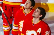  Calgary Flames Sean Monahan and Johnny Gaudreau watch a video tribute which honoured armed forces members on Armed Forces Appreciation Night before NHL action against the Winnipeg Jets in Calgary on Saturday, March 27, 2021.