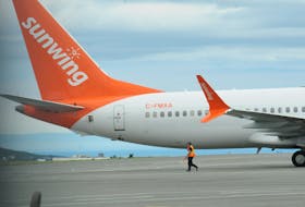St. John’s International Airport (SJIA) grounds crew personnel prepare this shown Sunwing Airlines aircraft for its 12:45 p.m. take-off flight Sunwing WG 818 for the skies over YYT on Thursday afternoon, August 25, 2022, outbound for the Lester B. Pearson International Airport in Toronto, Ontario, with a scheduled approximate landing at YYZ some three hours later. -Photo by Joe Gibbons/The Telegram