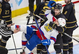 Edmonton Oil Kings forward Rilen Kovacevic is pulled down by the Brandon Wheat Kings' Caleb Hadland at Rogers Place on Sunday, Jan. 22, 2023.