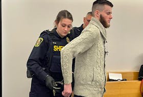 Sheriffs remove handcuffs from Sheldon Hibbs' wrists prior to the start of his preliminary inquiry in provincial court in St. John's Monday, Jan. 23. TARA BRADBURY • THE TELEGRAM