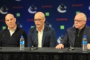  Canucks general manager Patrik Allvin talks about the hiring of Rick Tocchet (left) as new head coach while club president Jim Rutherford (right) looks on during a news conference at Rogers Arena on Sunday.