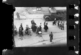 Jews being led to Umschlagplatz; photo taken from a window of St Zofia Hospital at the corner of Żelazna and Nowolipie Streets, most likely (to be confirmed) overlooking Nowolipie Street; author’s comment noted after the war at the back of the print held in the USHMM archive in Washington, DC:
”Scenes from the evacuation of the ghetto, ca 20 April 1943.”