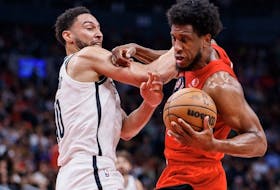 Ben Simmons of the Brooklyn Nets and Thaddeus Young of the Toronto Raptors battle or the ball during the second half of their NBA game at Scotiabank Arena on November 23, 2022 in Toronto, Canada. 