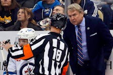 Winnipeg Jets head coach Rick Bowness listens to referee Tom Chmielewski during an NHL game on Jan. 13 against the Pittsburgh Penguins at PPG Paints Arena. - CHARLES LeCLAIRE / USA Today Sports
