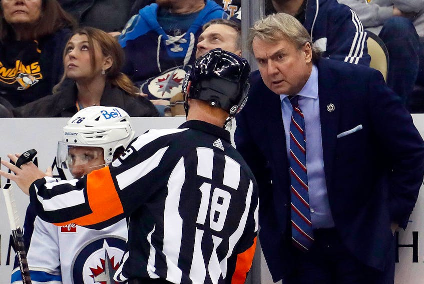 Winnipeg Jets head coach Rick Bowness listens to referee Tom Chmielewski during an NHL game on Jan. 13 against the Pittsburgh Penguins at PPG Paints Arena. - CHARLES LeCLAIRE / USA Today Sports
