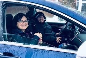 Aimee Brown, left, and Nancy MacIntyre sit in a vehicle outside of the Knights of Columbus on Plummer Avenue in New Waterford on Saturday. The two sat in the parking lot all night to be first in line to get tickets for this year’s New Waterford Coal Bowl Classic. CONTRIBUTED/AIMEE BROWN