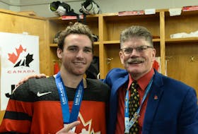 Two Prince Edward Islanders won gold in men’s hockey with Team Canada at the FISU Winter World University Games in Lake Placid, N.Y., on Jan. 23. UPEI Panthers forward TJ Shea, left, of Tignish and head coach Gardiner MacDougall of Bedeque celebrate in the team’s dressing room. U Sports • Special to The Guardian