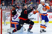  Ottawa Senators left wing Brady Tkachuk gets tangled up with New York Islanders defenceman Scott Mayfield during the first period at the Canadian Tire Centre on Wednesday, Jan. 25, 2023.