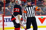  Referee Kevin Pollock explains to Ottawa Senators goaltender Cam Talbot during a stoppage in play why no penalty was called when Talbot was interfered with during the second period against the New York Islanders at the Canadian Tire Centre on Wednesday, Jan. 25, 2023. Talbot left the game with an injury.