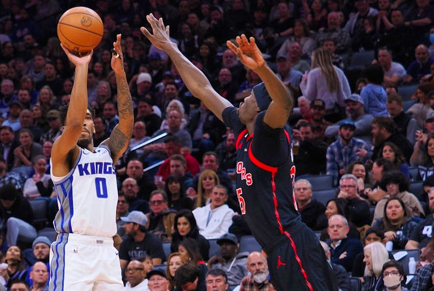 Sacramento Kings shooting guard Malik Monk (0) scores a three point basket against Toronto Raptors center Chris Boucher (25) during the fourth quarter at Golden 1 Center.