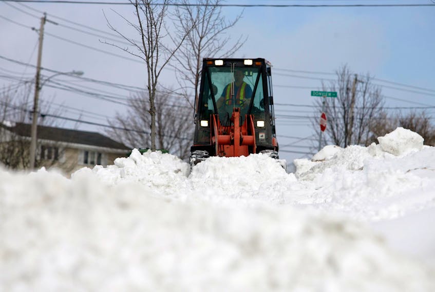 Feb. 13, 2006--A contractor clears the sidewalk along Dorthea Drive in Dartmouth following Sunday's snow storm. The old city of Dartmouth already has a tax levy to provide sidewalk clearing. HRM city council is debating extending sidewalk cleaning to the old city of Halifax.