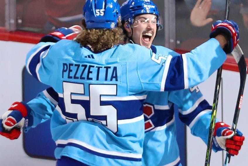 Canadiens' Rafael Harvey-Pinard  celebrates his goal with teammate Michael Pezzetta during the second period Thursday night at the Bell Centre.
