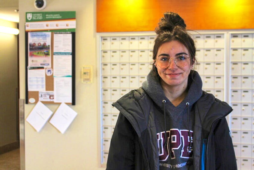 Baily Cox, first-year kinesiology student at UPEI, stands in the lobby of the Andrew Hall residence.
