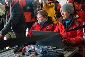 Jennifer Herbig, right, operates the camera software with a live-feed image, while Eugenie Jacobsen operates the winch tethered to the deployed deep-sea camera during the colossal squid project aboard the Ocean Endeavour cruiseship off the coast of Antarctica in December. John Bozinov photo