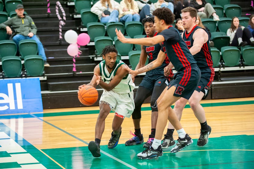 UPEI's Elijah Miller looks to pass the ball along the baseline in a 49-48 win over visiting UNB on Jan. 26. The Panthers hosted the Atlantic University Sport Men’s Basketball Conference game at the Chi-Wan Young Sports Centre. Janessa Hogan • UPEI Athletics