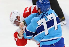 Montreal Canadiens' Kirby Dach throws a punch at Detroit Red Wings' Andrew Copp during second period in Montreal on Jan. 26, 2023.