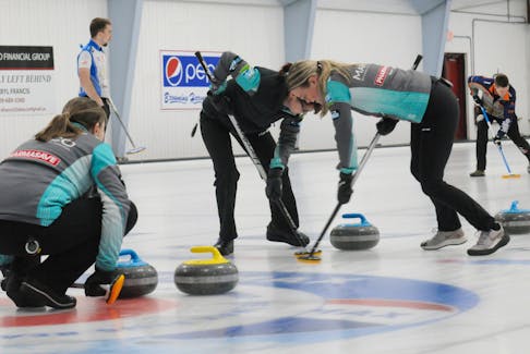 Skip Stacey Curtis (left) looks on as teammates third Erica Trickett (centre) and lead Camille Burt (right) take a shot by down ice in the final of their 2023 provincial Scottie’s Tournament of Hearts ladies curling championship at the Re/Max Centre on Jan. 29. Curtis defeated the Heather Strong skipped rink 11-8 and will now represent Newfoundland and Labrador at the national Scottie’s Tournament of Hearts tournament in British Columbia from Feb. 17-26. -Photo by Joe Gibbons/The Telegram